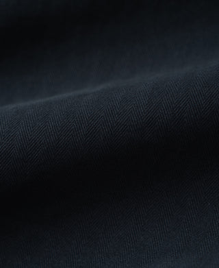 Navy herringbone textured fabric close-up