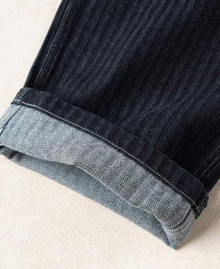 Indigo denim pants cuff with herringbone lining and stitched hem band