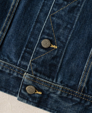 Indigo denim jacket chest pocket flaps with two metal snap buttons and trim