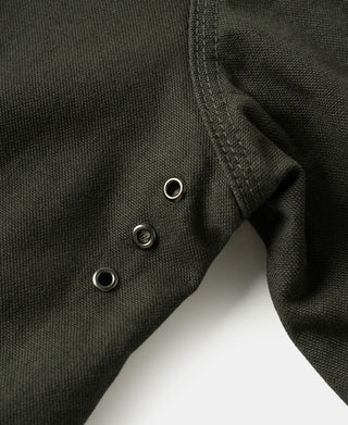 Olive canvas jacket side with metal eyelets and fabric seam detail