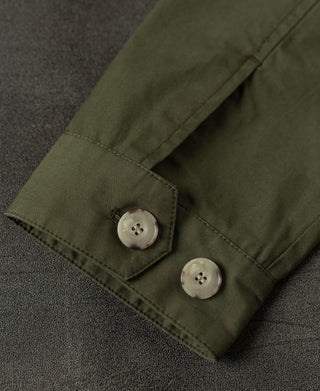 Olive jacket cuff with two snap buttons and stitched hem