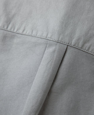 Gray oxford shirt seam and stitching detail near shoulder