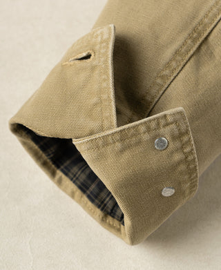 Washed khaki cossack jacket detail: plaid inner cuff and two metal snap buttons