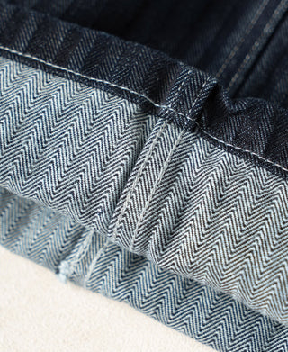 Indigo denim pants cuff with herringbone lining and reinforced stitch seam