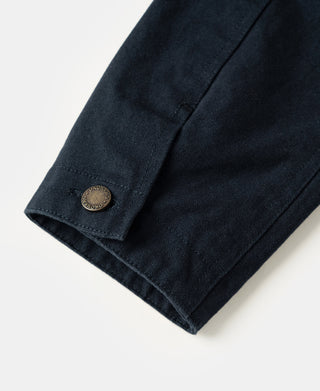 Navy cotton canvas field jacket sleeve cuff with metal button and stitched hem