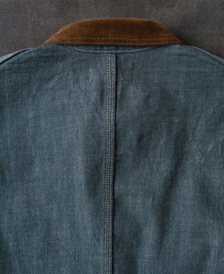 Blue denim barn jacket back view with brown corduroy-style collar and center seam