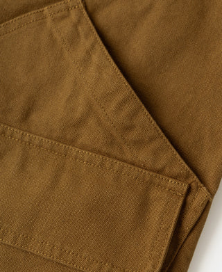 Khaki cotton canvas hunting jacket close-up of angled pocket and seam stitching