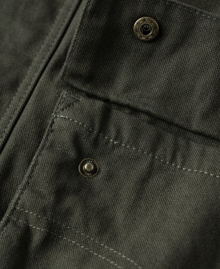 Olive canvas field jacket chest flap pocket with metal snap and stitching