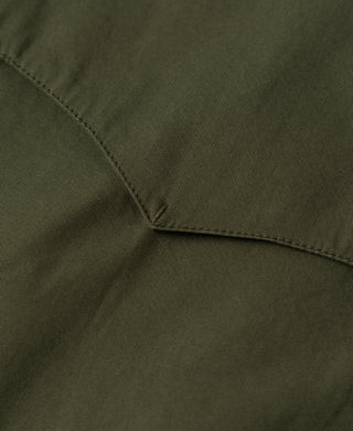 Olive jacket sleeve seam with stitched edge and folded detail