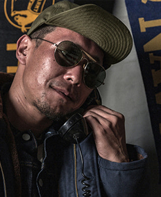 Olive A-3 flight cap worn with aviator goggles, Army Air Forces emblem on front