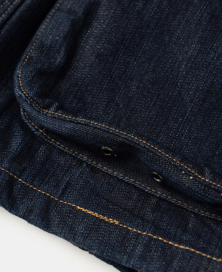 Indigo denim field jacket lower flap pocket with double rivet buttons.
