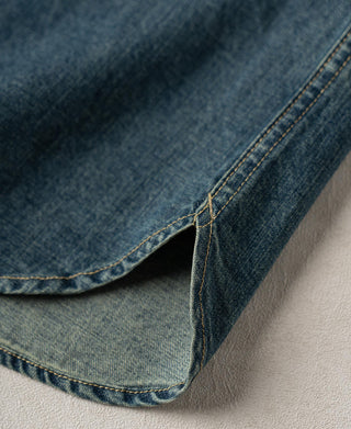 Denim shirt hem with side slit and contrast stitch along the edge