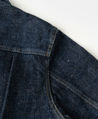Indigo denim jacket yoke and seam detail with contrast yellow stitching