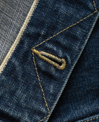 Indigo denim pocket corner detail with angled bartack reinforcement