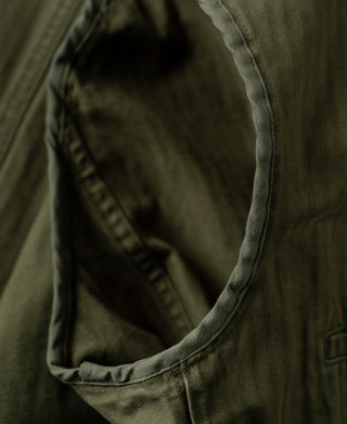 Olive blazer interior with curved seam and smooth lining fabric at the collar