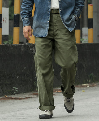 Olive fatigue trousers with cuffed hems and tapered straight-leg silhouette