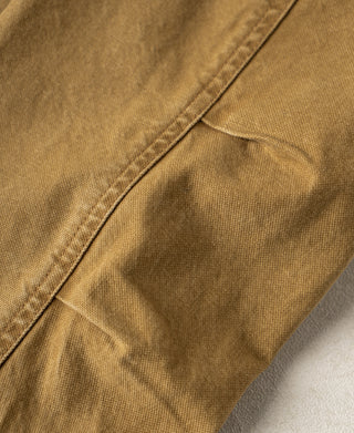 Khaki canvas field jacket with close-up of a panel seam