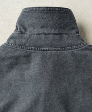 Back of a gray-blue jacket with a raised collar and stitched yoke