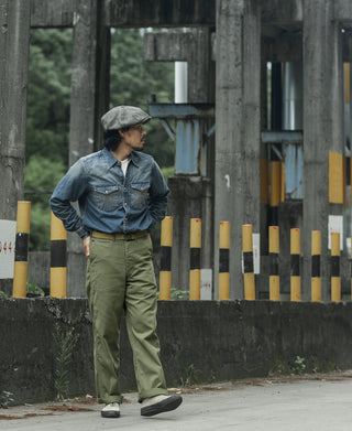 Olive fatigue trousers with side pockets, relaxed rise, and cuffed leg hems