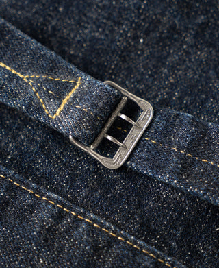 Indigo denim jacket belt buckle close-up with silver-tone metal hardware