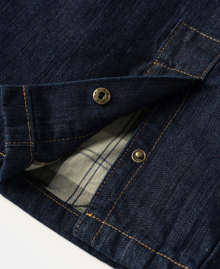 Indigo denim field jacket interior pocket with plaid lining and snap.