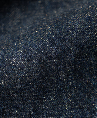 Indigo neppy selvedge denim fabric texture close-up with speckled surface