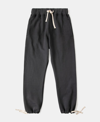 Black terry sweatpants with elastic waistband, white drawstring, cuffed hems