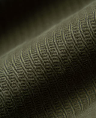 Olive herringbone fabric texture close-up with fine diagonal weave pattern