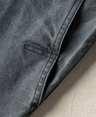 Gray-blue canvas hunting jacket with a stitched seam and small fabric loop