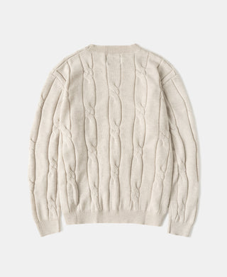 Apricot wool-blend cable knit crewneck sweater, back view with ribbed hem