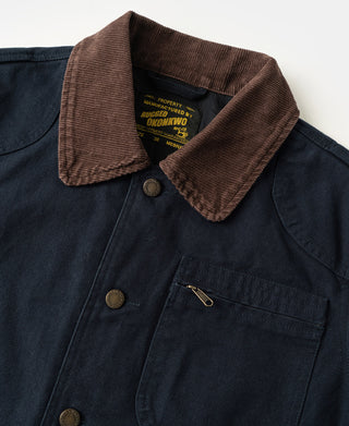 Navy jacket with brown corduroy collar, chest pockets, and metal button details