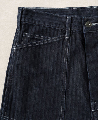 Indigo denim fatigue pants front view with belt loops and pleated pocket opening