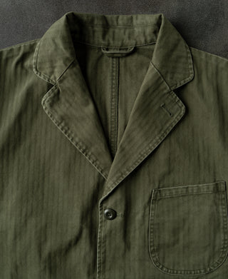 Olive herringbone blazer with wide lapels and chest pocket flap