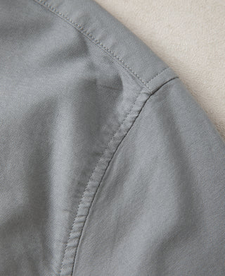 Gray oxford shirt sleeve seam with stitched cuff edge