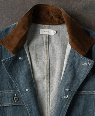 Brown corduroy-lined collar on sage blue denim barn jacket with inner label