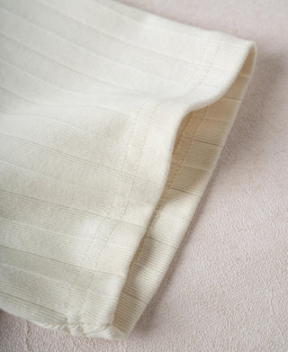 Oatmeal white ribbed cotton T-shirt sleeve cuff and hem seam detail