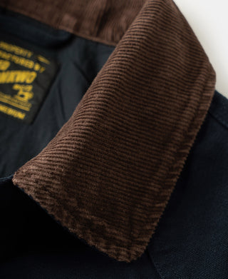Brown corduroy-style collar detail at neckline on navy jacket