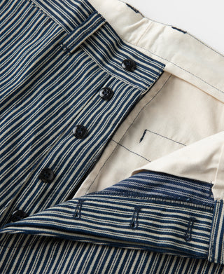 Striped trousers waistband interior with black buttons and off-white lining.