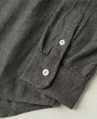 Close-up of dark gray work shirt chest pocket and white buttons