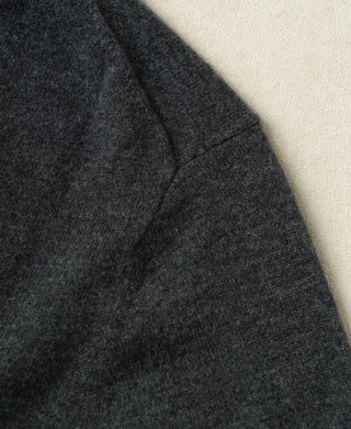 Heather gray sleeve seam and knit texture close-up on merino wool sweater