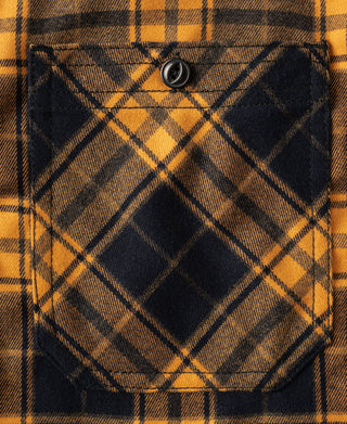 Yellow and navy plaid chest pocket with button closure on work shirt