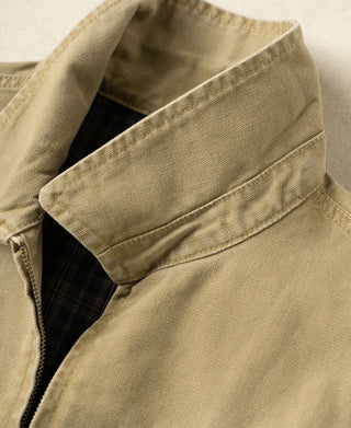 Washed khaki cossack jacket detail: plaid-lined collar and angled shoulder seam