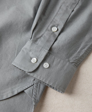 Gray button-down shirt cuff with white buttons and stitched placket