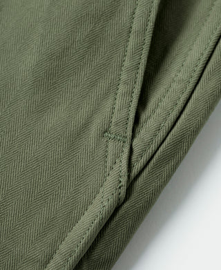 Olive fatigue trousers fabric weave with side panel seam and stitching
