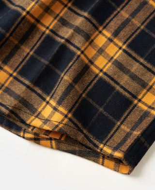 Yellow and navy plaid hem corner detail on a work shirt