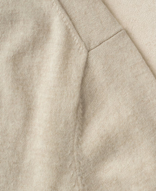Apricot merino wool sweater side seam knit texture close-up.