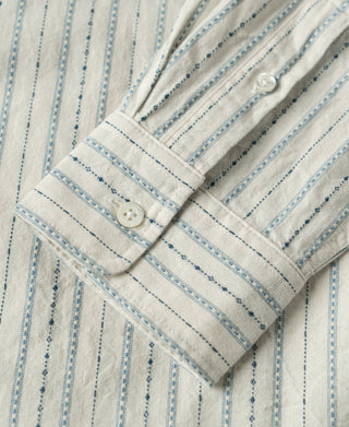 Close-up of striped shirt cuff with button and sleeve placket