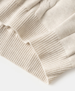 Close-up of apricot cable knit cuff with ribbed trim