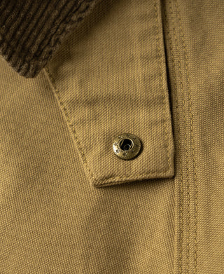 Khaki canvas field jacket close-up of button at chest pocket flap