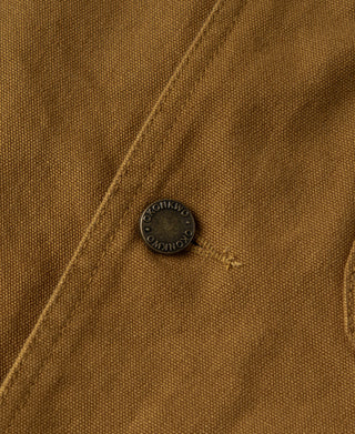 Khaki jacket close-up of round snap button on chest panel